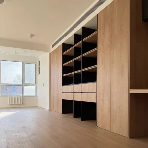 Custom Built in Bookshelf with Work Desk Featuring Open Shelves Storage Drawers and a Floating Design