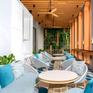 Tropical Resort Hotel Waiting Space Turnkey Hotel Chairs Grade Comfort Fabric Lounge Chairs Wood Frames Rattan Base Round Table